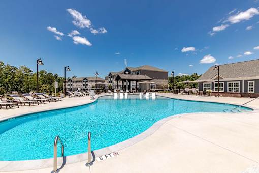A large swimming pool with a 5 feet marking on the side.