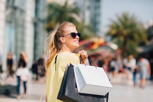 young woman with shopping bags in the city