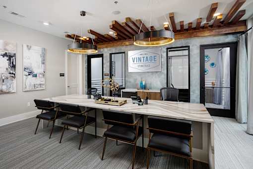 A conference room with a long table and chairs.