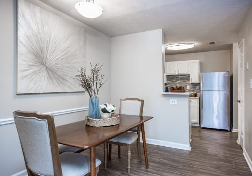 an open kitchen and dining room with a table and chairs