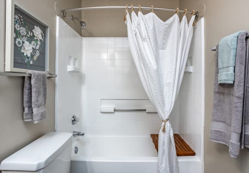 a bathroom with a shower curtain and a tub and a sink
