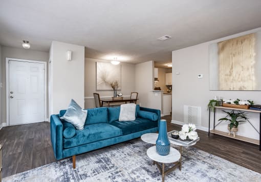 a living room with a blue couch and a table