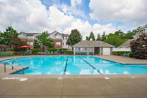 A large swimming pool in front of a building.