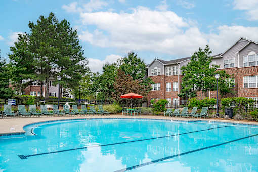 A swimming pool in front of apartment buildings.