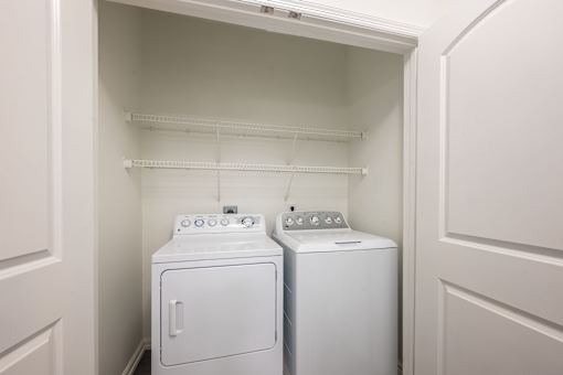 A white washer and dryer in a small laundry room.