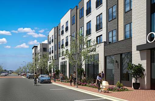 A street view of a residential area with apartment buildings and people walking on the sidewalk.