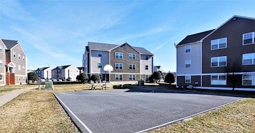 A parking lot in front of apartment buildings.