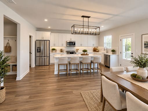 A modern kitchen with a dining table and chairs.