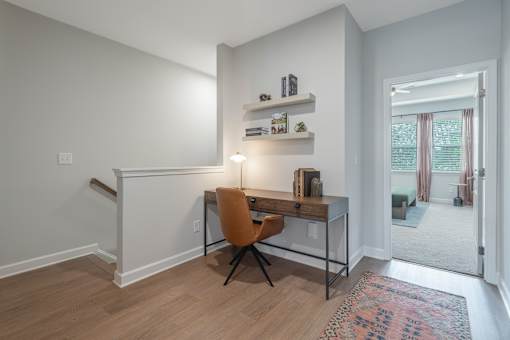 A room with a desk and a chair.