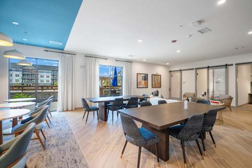 A large conference room with a long table and chairs.