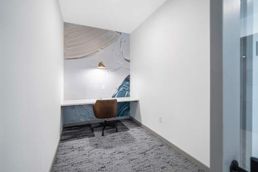 A room with a brown chair and a blue couch.