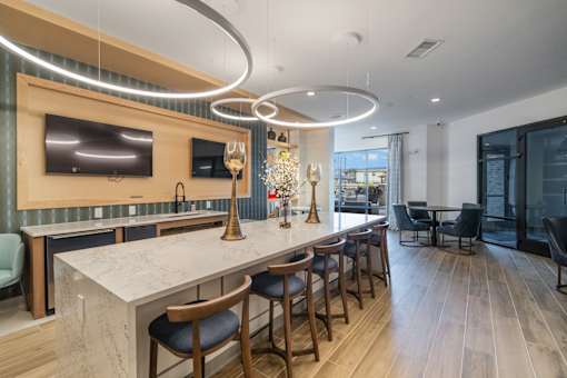 A modern kitchen with a bar area and a dining area.