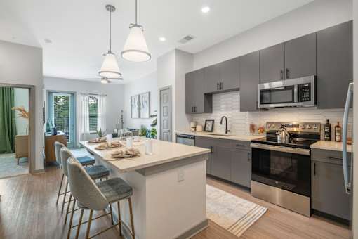 A modern kitchen with a dining table and chairs.