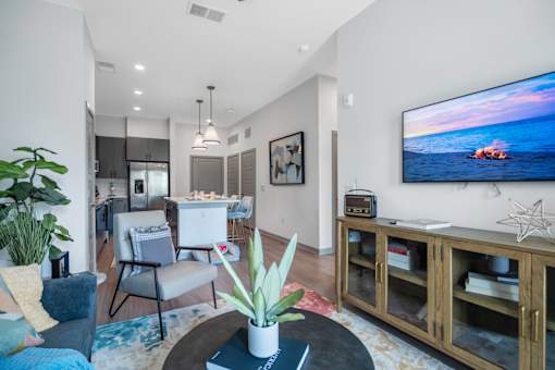 A modern living room with a flat screen TV mounted on the wall.