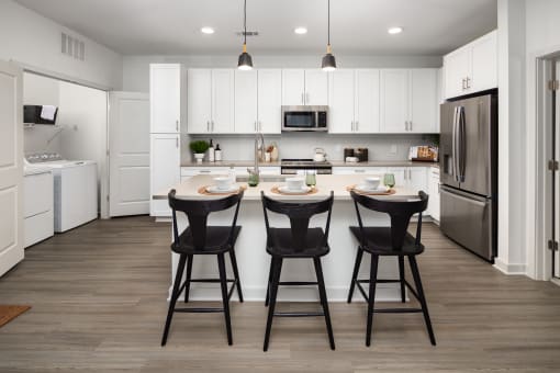 a kitchen with a center island with three bar stools
