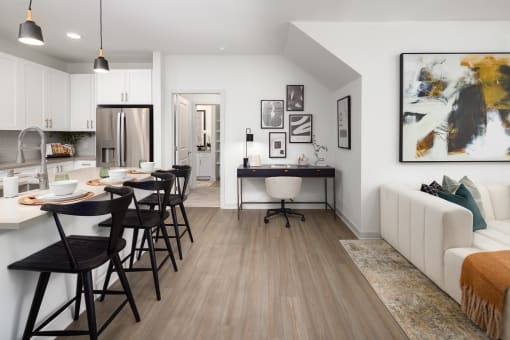 a living room and kitchen with a dining room table and chairs
