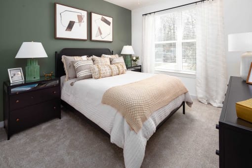 1-Bedroom Apartments in Acworth, GA - The Brookstone - Bedroom with Plush Carpeting, Bed, Nightstands with Drawers and Lamps, Dresser, and Large Window.
