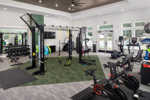 a home gym with exercise equipment and a tv