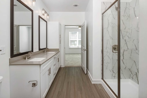 a bathroom with a shower and a sink and a mirror