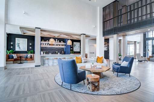 A modern living room with a blue chair and a coffee table.