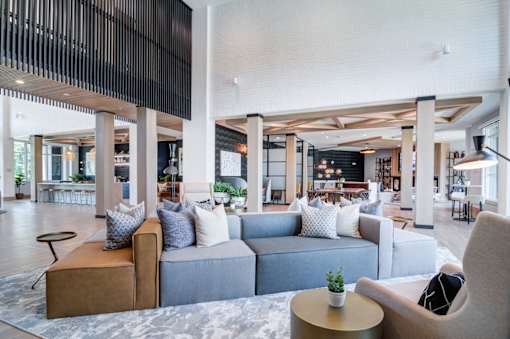 A modern living room with a grey sofa and a wooden coffee table.