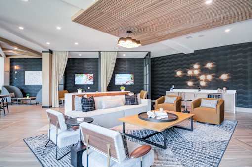 A modern living room with a wooden ceiling and a black accent wall.