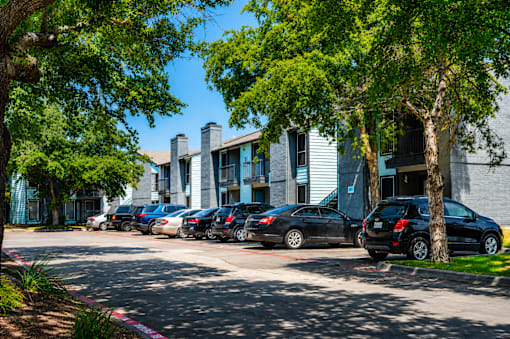 A row of cars parked in front of a building.