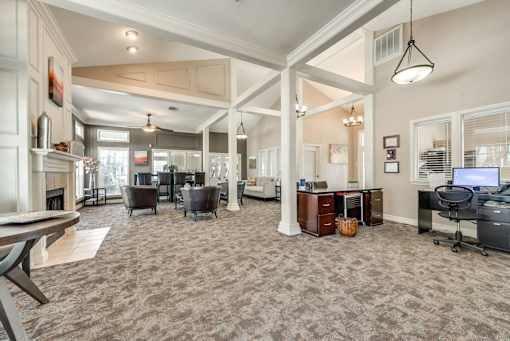 A spacious living room with a fireplace and a large window.