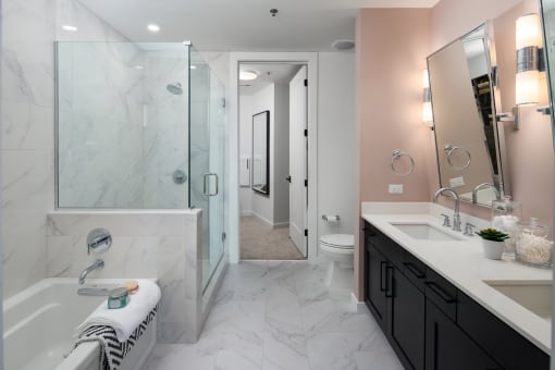 a bathroom with a large tub and a shower with a glass door