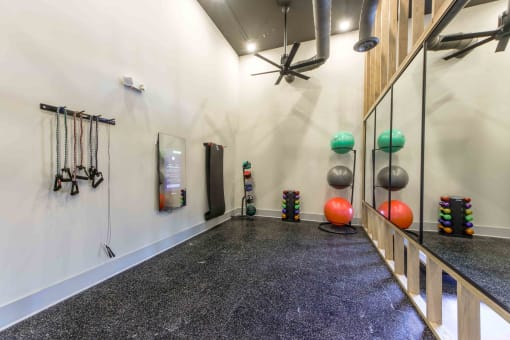 a workout room with weights on the wall and a treadmill