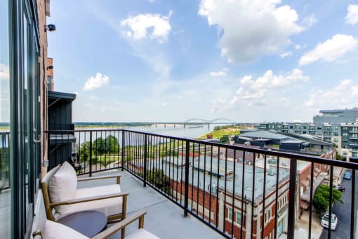 a balcony with a view of a city and a river