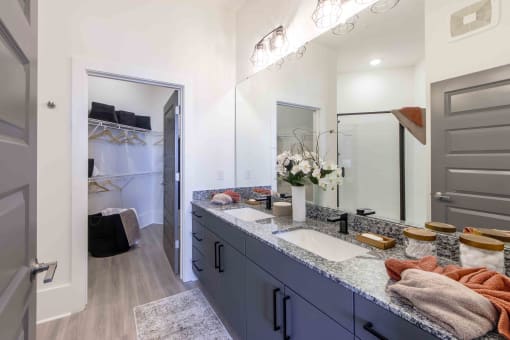 a blue and white bathroom with a sink and a mirror