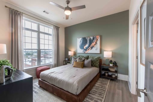 a bedroom with a bed and a ceiling fan