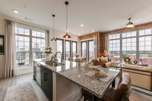 an open kitchen and living room with large windows
