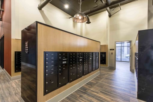 a locker room in a gym with a wood floor and lockers