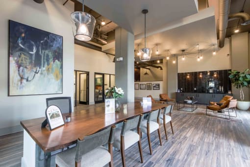 a communal table and chairs in a room with a lobby
