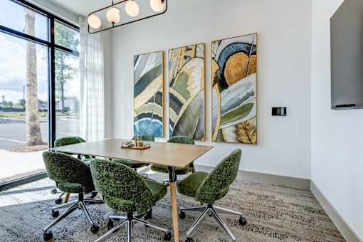 A conference room with a long table and chairs.