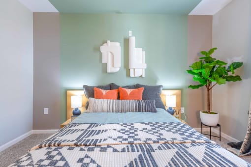 a bedroom with a bed and a plant