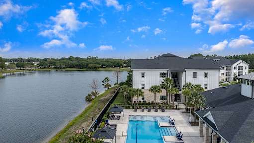 A large house with a pool in front of it.