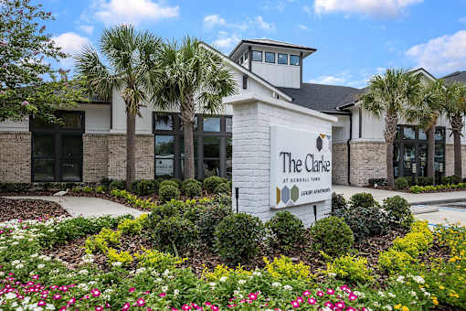 The Clarke at Newberry is a beautiful building surrounded by flowers.