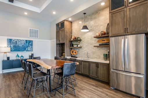 A modern kitchen with a wooden table and chairs.
