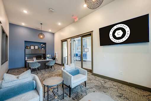 A living room with a grey couch and a blue chair.