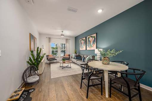 A living room with a white table and chairs.