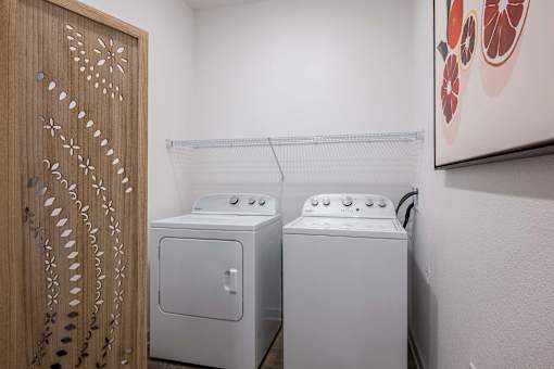 A washing machine and dryer in a small room.