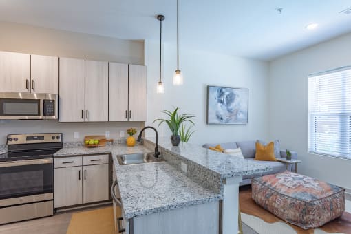 a kitchen with granite counter tops and stainless steel appliances