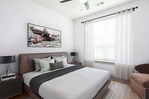 A bedroom with a large bed and a painting on the wall.