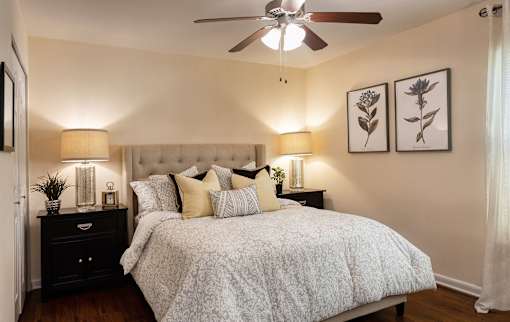 A bedroom with a large bed and a ceiling fan at Legacy, Tampa, FL, 33603