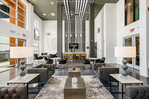 A modern living room with a long table and chairs.