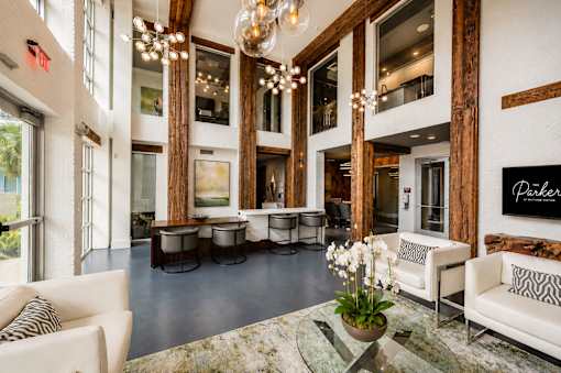 A living room with a couch, chairs, and a coffee table.