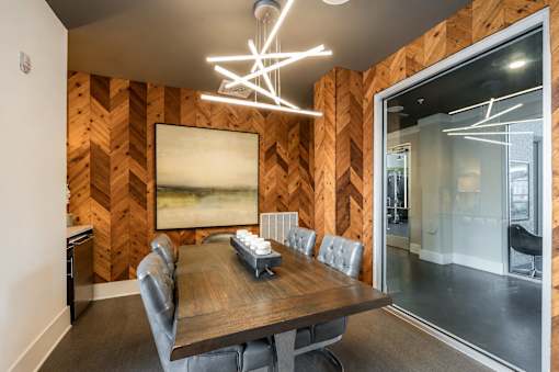 A conference room with a wooden table and chairs.
